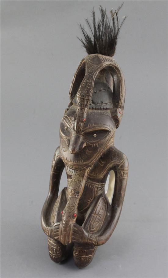 A Goroka Valley hardwood figure, with bone inset eyes and beaded details, from the collection of Mick Leahy, height 31cm